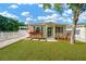 Charming single-story home with a lush green lawn, well-manicured landscaping, and a white picket fence at 3002 E 24Th Ave, Tampa, FL 33605