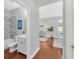 Hallway view to the bathroom, living room, and dining room with hardwood flooring at 3002 E 24Th Ave, Tampa, FL 33605