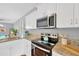 Well-equipped kitchen featuring granite countertops, stainless steel appliances, and white cabinetry at 3002 E 24Th Ave, Tampa, FL 33605