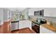 Modern kitchen featuring stainless steel appliances, granite countertops, and spacious layout at 3002 E 24Th Ave, Tampa, FL 33605