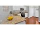 Well-lit kitchen showcasing granite countertops, stainless appliances and wood flooring at 3002 E 24Th Ave, Tampa, FL 33605