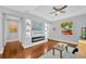 Bright living room featuring a modern fireplace, built-in shelving, and hardwood floors at 3002 E 24Th Ave, Tampa, FL 33605