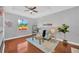 Cozy living room with hardwood floors, a ceiling fan, and a bright window view at 3002 E 24Th Ave, Tampa, FL 33605