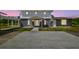 The house has a combination of white and gray brick, with an ample parking area at 30229 Coast Ln, Wesley Chapel, FL 33545