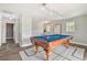 Well-lit game room with a vintage-style pool table and stylish decor at 30229 Coast Ln, Wesley Chapel, FL 33545