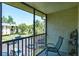 This balcony features a relaxing chair and views of the lush, green landscaping at 3166 Lake Pine S Way # E3, Tarpon Springs, FL 34688