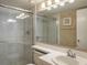Clean bathroom with a glass-enclosed shower, modern fixtures, and ample counter space, offering a functional design at 3166 Lake Pine S Way # E3, Tarpon Springs, FL 34688
