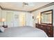Inviting bedroom featuring a view of the en-suite bathroom, complemented by a dresser and comfortable furnishings at 3166 Lake Pine S Way # E3, Tarpon Springs, FL 34688