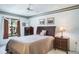 Cozy bedroom with neutral tones and ample natural light, featuring a ceiling fan and simple, elegant decor at 3166 Lake Pine S Way # E3, Tarpon Springs, FL 34688