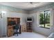 Versatile room with desk, TV, and view of the exterior; ready for use as a bedroom, home office, or playroom at 3166 Lake Pine S Way # E3, Tarpon Springs, FL 34688