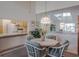 A dining table is nestled near a mirrored wall and has a view into the nearby, efficient kitchen at 3166 Lake Pine S Way # E3, Tarpon Springs, FL 34688