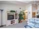 Bright living room with a ceiling fan, tv, and large potted plant near the pass-through kitchen at 3166 Lake Pine S Way # E3, Tarpon Springs, FL 34688