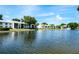 Water view of community pond and fountain and the white buildings reflecting off the water at 3166 Lake Pine S Way # E3, Tarpon Springs, FL 34688