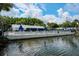 Enjoy the community pool surrounded by lush greenery and a tranquil lake at 3166 Lake Pine S Way # E3, Tarpon Springs, FL 34688