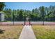 Community tennis courts surrounded by green trees and greenery and accessible via a gate at 3166 Lake Pine S Way # E3, Tarpon Springs, FL 34688