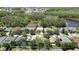 Aerial view of a two-story home with beautiful backyard, outlined in red at 3243 Ashmonte Dr, Land O Lakes, FL 34638