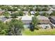 Home featuring screened in pool and landscaped backyard with views of community pond at 3243 Ashmonte Dr, Land O Lakes, FL 34638