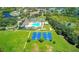 The aerial view reveals a pool, tennis courts, and basketball courts, perfect for an active lifestyle at 3243 Ashmonte Dr, Land O Lakes, FL 34638