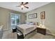 Bedroom featuring a ceiling fan, carpet, and neutral wall color with access to a patio at 3243 Ashmonte Dr, Land O Lakes, FL 34638