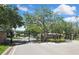 Elegant gated community entrance featuring stone pillars and lush landscaping at 3243 Ashmonte Dr, Land O Lakes, FL 34638