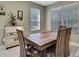 Dining area with wood table, chairs, and bright natural light at 3243 Ashmonte Dr, Land O Lakes, FL 34638