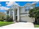 A charming two-story home with a well-manicured lawn, complemented by an attached two-car garage at 3243 Ashmonte Dr, Land O Lakes, FL 34638