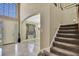 Elegant foyer featuring a staircase, large windows, and an arched entryway at 3243 Ashmonte Dr, Land O Lakes, FL 34638