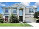 Charming two-story home featuring lush landscaping and a well-manicured lawn at 3243 Ashmonte Dr, Land O Lakes, FL 34638