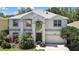 Charming two-story home with meticulously landscaped front yard and attached two-car garage at 3243 Ashmonte Dr, Land O Lakes, FL 34638