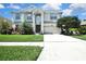 Charming two-story home featuring lush landscaping and a well-manicured lawn at 3243 Ashmonte Dr, Land O Lakes, FL 34638