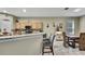 Kitchen featuring granite countertops, breakfast bar, and wood cabinetry at 3243 Ashmonte Dr, Land O Lakes, FL 34638