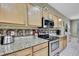 Bright kitchen with wooden cabinets, granite countertops, and stainless steel appliances at 3243 Ashmonte Dr, Land O Lakes, FL 34638