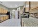 Bright kitchen featuring stainless steel appliances, wooden cabinets, granite countertops, and tiled floors at 3243 Ashmonte Dr, Land O Lakes, FL 34638