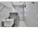 This laundry room is equipped with washer, dryer, sink, overhead rack, and storage cabinets at 3243 Ashmonte Dr, Land O Lakes, FL 34638