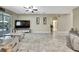 Spacious living room with marble flooring, media center, and neutral paint at 3243 Ashmonte Dr, Land O Lakes, FL 34638