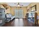 Charming living room with wooden floors, patio access, a gun safe, and modern decor at 3243 Ashmonte Dr, Land O Lakes, FL 34638