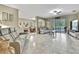 Open living room with sliding glass doors to the lanai and marble flooring at 3243 Ashmonte Dr, Land O Lakes, FL 34638