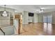Spacious living room with hardwood floors, ceiling fan, and doors to outdoor balcony at 3243 Ashmonte Dr, Land O Lakes, FL 34638