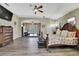 This spacious main bedroom features wood-look floors, a ceiling fan and living room views at 3243 Ashmonte Dr, Land O Lakes, FL 34638