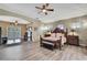 Spacious main bedroom featuring a ceiling fan and wood flooring at 3243 Ashmonte Dr, Land O Lakes, FL 34638