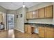 Bright office area featuring wood cabinets and a green granite countertop at 3243 Ashmonte Dr, Land O Lakes, FL 34638