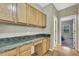 Spacious office area features wood floors, wood cabinets, and green granite countertop at 3243 Ashmonte Dr, Land O Lakes, FL 34638