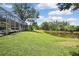 Lush backyard featuring a serene pond with mature trees and a private, peaceful setting at 3243 Ashmonte Dr, Land O Lakes, FL 34638