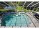 Aerial view of the screened pool and spa with statues, BBQ grill, and a serene pond in the background at 3243 Ashmonte Dr, Land O Lakes, FL 34638
