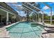 Sparkling pool with screened enclosure surrounded by manicured greenery at 3243 Ashmonte Dr, Land O Lakes, FL 34638