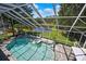 The screened pool and spa offer a peaceful retreat with a view of a serene pond at 3243 Ashmonte Dr, Land O Lakes, FL 34638
