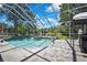 Stunning screened pool overlooking a serene pond, perfect for luxurious outdoor living and relaxation at 3243 Ashmonte Dr, Land O Lakes, FL 34638
