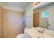 Bathroom featuring tiled shower and single sink vanity at 3262 Montclair Cir, North Port, FL 34287
