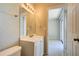 Bathroom featuring a single sink vanity and view of a second room at 3262 Montclair Cir, North Port, FL 34287