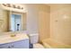 Well-lit bathroom featuring a single sink vanity and a tub with tile surround at 3262 Montclair Cir, North Port, FL 34287